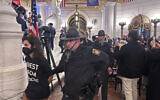 Police arrest some of about 200 people taken into custody on February 5, 2024, in the Rotunda of the State Capitol in Harrisburg, Pennsylvania. (AP Photo/ Mark Scolforo)