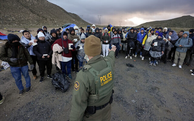 A Border Patrol agent asks asylum-seeking migrants to line up in a makeshift, mountainous campsite after the group crossed the border with Mexico, Friday, Feb. 2, 2024, near Jacumba Hot Springs, Calif. (AP Photo/Gregory Bull) A Border Patrol agent asks asylum-seeking migrants to line up in a makeshift, mountainous campsite after the group crossed the border with Mexico, Friday, Feb. 2, 2024, near Jacumba Hot Springs, Calif. (AP Photo/Gregory Bull)