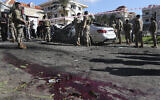Lebanese army soldiers gather around a damaged car near the coastal town of Jadra, south Lebanon, February 10, 2024. (AP Photo/Mohammed Zaatari)