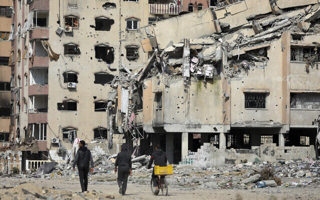 Palestinians walk through the destruction left by the Israeli strikes on Gaza City, Feb. 10, 2024. (AP/Mohammed Hajjar) Palestinians walk through the destruction left by the Israeli strikes on Gaza City, Feb. 10, 2024. (AP/Mohammed Hajjar)