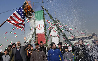 Demonstrators burn a US flag during their annual rally commemorating Iran's 1979 Islamic Revolution in Tehran, Iran, February 11, 2024. (Vahid Salemi/AP)