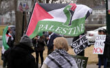 Pro-Palestinian, anti-Israel demonstrators display signs while marching during a protest held to call for a cease fire in the war in Gaza, February 11, 2024, in Braintree, Mass. (AP Photo/Steven Senne)