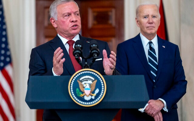 Jordan's King Abdullah II, accompanied by President Joe Biden, right, speaks in the Cross Hall of the White House in Washington, Monday, Feb. 12, 2024. (AP Photo/Andrew Harnik)