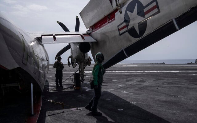 Crew members inspect C-2 Greyhound (COD) after landing on the USS aircraft carrier Dwight D. Eisenhower, in the south Red Sea, February 12, 2024. (Bernat Armangue/AP)