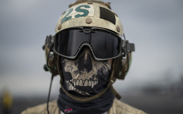 A crew member on the deck of the USS aircraft carrier Dwight D. Eisenhower, in the south Red Sea, February 13, 2024. (Bernat Armangue/AP)