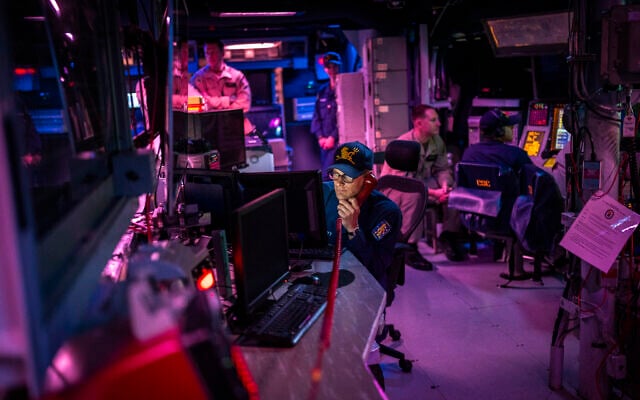Crew members work in the combat information center of the USS Gravely (DDG 107) destroyer in the south Red Sea, February 13, 2024. (Bernat Armangue/AP)