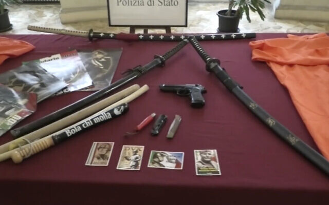 This picture taken from a publicly distributed police video shows some of the items recovered in the homes of 24 people investigated for apology of fascism in Ferrara, northern Italy, Feb. 14, 2024. (Italian Police via AP)