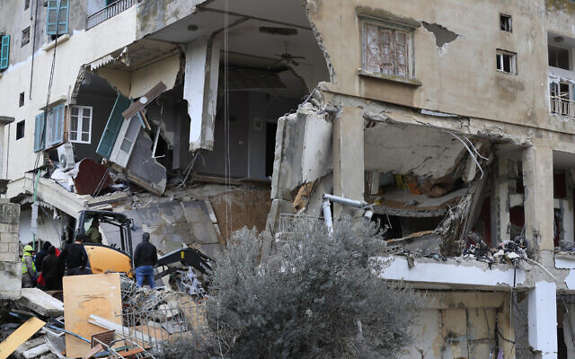 Civil defense and rescue workers remove rubble from a building that was hit Wednesday night by an Israeli airstrike, in Nabatiyeh town, south Lebanon, Thursday, Feb. 15, 2024.  (AP Photo/Mohammed Zaatari)