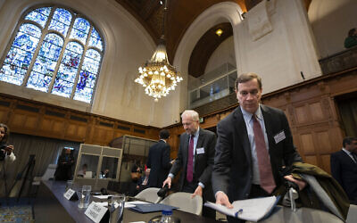 Richard C. Visek, acting legal adviser of the US Department of state, right, arrives to address the United Nations' highest court during hearings in The Hague, Netherlands, Feb. 21, 2024, into the legality of Israel's 57-year rule of the West Bank and East Jerusalem. (AP Photo/Peter Dejong)