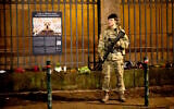 Illustrative: A soldier of the Danish Army (Forsvaret) guards the Copenhagen Synagogue, December 16, 2023. (Nils Meilvang/Ritzau Scanpix via AP, File)