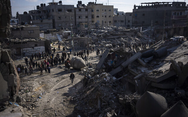 Palestinians look at the destruction after an Israeli strike in Rafah, Gaza Strip, February 22, 2024. (AP Photo/Fatima Shbair)