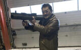 This image provided by the US Attorney, Southern District of New York shows a photo from a complaint document filed by SDNY of Takeshi Ebisawa handling a rocket launcher.  Federal prosecutors say the leader of a Japan-based crime syndicate conspired to traffic uranium and plutonium from Myanmar in the belief that Iran would use it for nuclear weapons. (US Attorney, Southern District of New York via AP)