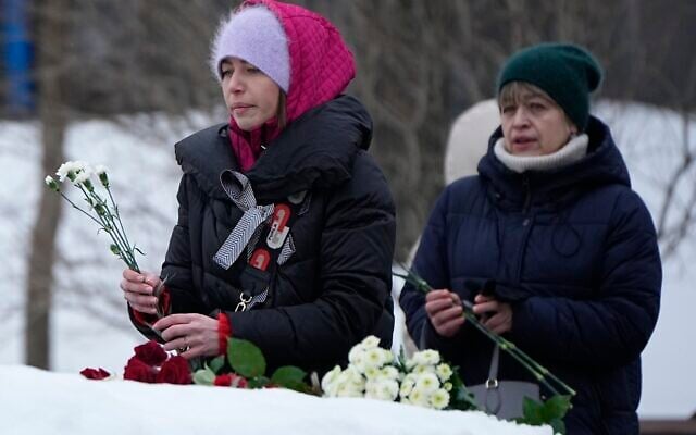 Women lay flowers to pay tribute to Alexei Navalny at the monument, a large boulder from the Solovetsky islands, where the first camp of the Gulag political prison system was established, near the historical Federal Security Service (FSB, Soviet KGB successor) building in Moscow, Russia, on Saturday, Feb. 24, 2024. (AP Photo/Alexander Zemlianichenko) Women lay flowers to pay tribute to Alexei Navalny at the monument, a large boulder from the Solovetsky islands, where the first camp of the Gulag political prison system was established, near the historical Federal Security Service (FSB, Soviet KGB successor) building in Moscow, Russia, on Saturday, Feb. 24, 2024. (AP Photo/Alexander Zemlianichenko)