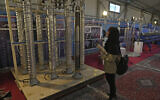 A student looks at Iran's domestically built centrifuges in an exhibition of the country's nuclear achievements, in Tehran, Iran, February 8, 2023. (AP Photo/Vahid Salemi)