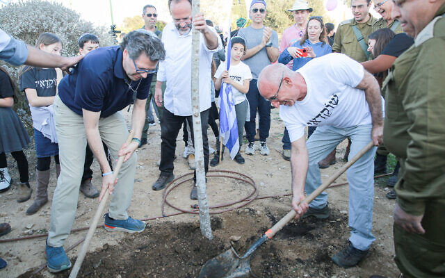 Residents of Shokeda plant a tree after returning to their moshav from temporary accommodations in Neve Ilan on February 8, 2024. (Nehorai Samimi) Residents of Shokeda plant a tree after returning to their moshav from temporary accommodations in Neve Ilan on February 8, 2024. (Nehorai Samimi)
