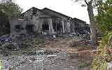 Residential homes, severely damaged during Hamas's October 7 onslaught on southern Israel, line a street in the Olives Neighborhood of Kibbutz Be'eri on January 1, 2024. (Canaan Lidor/Times of Israel)