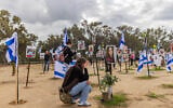 People visit the site of the Supernova music festival massacre in Re'im, January 14, 2024. (Chaim Goldberg/Flash90)