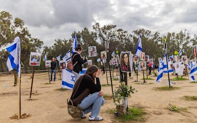People visit the site of the Supernova music festival massacre in Re'im, January 14, 2024. (Chaim Goldberg/Flash90)