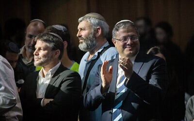 National Security Minister Itamar Ben Gvir (R) and Finance Minister Bezalel Smotrich (L) are seen at a 'Victory Conference' calling for renewed Jewish settlement in the Gaza Strip, at the International Convention Center in Jerusalem, January 28, 2024. (Chaim Goldberg/Flash90)