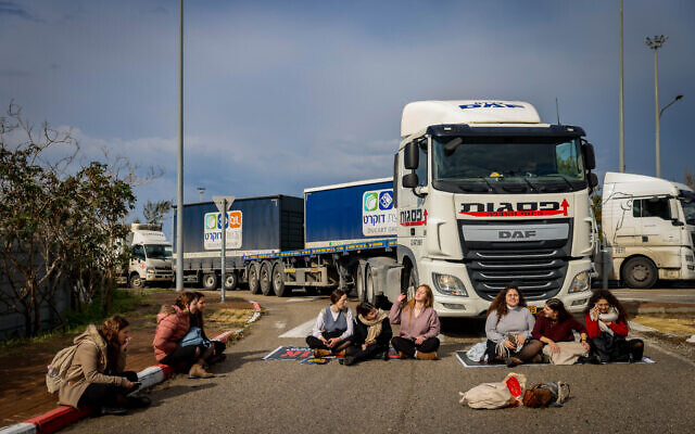 Activists for hostages block aid trucks from leaving the Ashdod Port during a protest against aid reaching the Gaza Strip, in Ashdod, February 1, 2024. (Chaim Goldberg/Flash90) Activists for hostages block aid trucks from leaving the Ashdod Port during a protest against aid reaching the Gaza Strip, in Ashdod, February 1, 2024. (Chaim Goldberg/Flash90)
