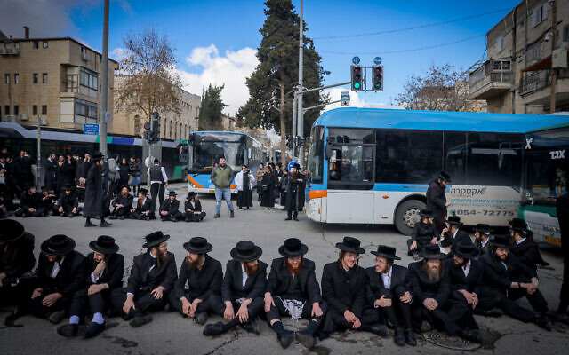 Haredi men block a Jerusalem road during a protest against the autopsy of a young boy who died, February 6, 2024 (Chaim Goldberg/Flash90) Haredi men block a Jerusalem road during a protest against the autopsy of a young boy who died, February 6, 2024 (Chaim Goldberg/Flash90)