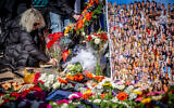 Families of Israelis who were murdered by Hamas terrorists at the Nova festival place pictures of their loved ones outside the Knesset in Jerusalem on February 7, 2024. (Yonatan Sindel/Flash90)