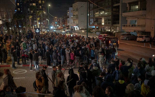 Demonstrators carry placards during a protest following the death in jail of Russian opposition leader Alexei Navalny, outside the Russian Embassy in Tel Aviv, on February 16, 2024. (Erik Marmor/Flash90)