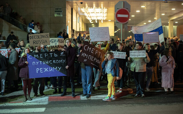 Demonstrators carry placards during a protest following the death in jail of Russian opposition leader Alexei Navalny, outside the Russian Embassy in Tel Aviv, on February 16, 2024. (Erik Marmor/Flash90)