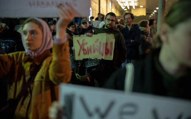 Demonstrators carry placards during a protest following the death in jail of Russian opposition leader Alexei Navalny, outside the Russian Embassy in Tel Aviv, on February 16, 2024. (Erik Marmor/Flash90)