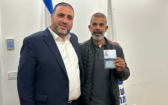 Interior Minister Moshe Arbel stands with Hamid Abu Ar'ar as he shows his new Israeli ID, February 21, 2024. (Courtesy) Interior Minister Moshe Arbel stands with Hamid Abu Ar'ar as he shows his new Israeli ID, February 21, 2024. (Courtesy)