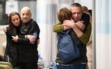 Louis Har (in black) and Fernando Marman reuniting with their loved ones, at Sheba Medical Center, February 12, 2024 (IDF Spokesperson)