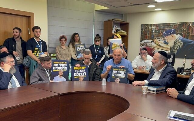 Shas leader Aryeh Deri with relatives of hostages during a faction meeting in the Knesset, February 12, 2024. (Courtesy)