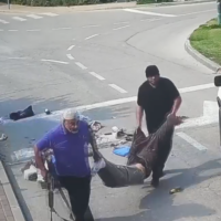 Screenshot from video showing an UNRWA worker next to a white UN jeep, abducting the body of Yonatan Samerano, who was killed by Hamas terrorists on October 7, 2023. (Screenshot)