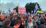 Demonstrators gather outside the Knesset to protest the government's 2024 wartime budget on February 19, 2024. (Charlie Summers/Times of Israel)