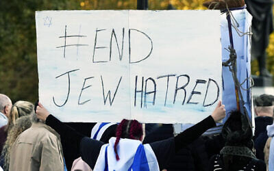 FILE - An Israeli supporter holds up a placard saying 'End Jew Hatred' as she takes part in a protest where placards with the faces and names of people believed taken hostage and held in Gaza were held up during a protest in Trafalgar Square, London, on October 22, 2023. (AP Photo/Frank Augstein, File)