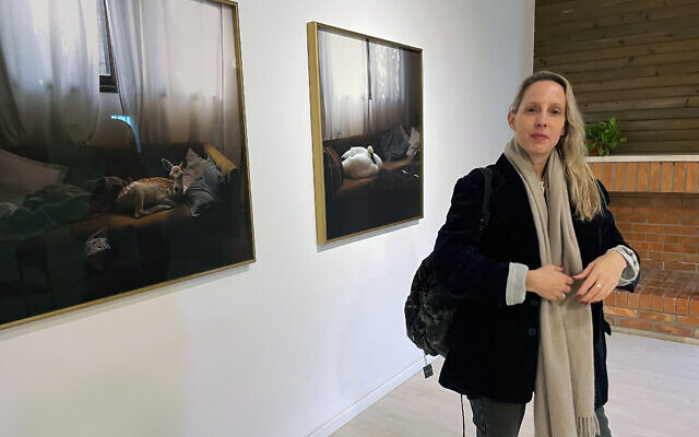 Sofie Berzon MacKie at her new exhibit, 'Silvery Water and Starry Earth' at Jerusalem's Studio of Her Own gallery, opened January 12, 2024 (Jessica Steinberg/Times of Israel)