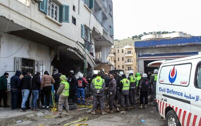 Rescuers check a building targeted overnight by an Israeli airstrike in the southern Lebanese city of Nabatieh on February 15, 2024. (Mahmoud ZAYYAT / AFP)