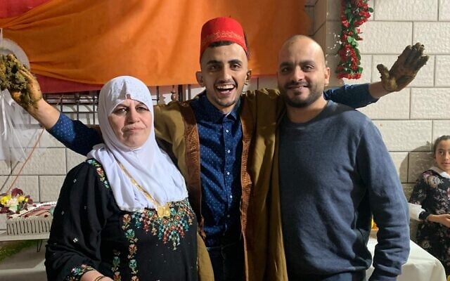 Kaid Abu Latif (far right) with his youngest brother, Ahmad Abu Latif and their mother, Mansoura Abu Latif, before Ahmad was killed in Gaza on January 22, 2024 during combat as a reservist (Courtesy)