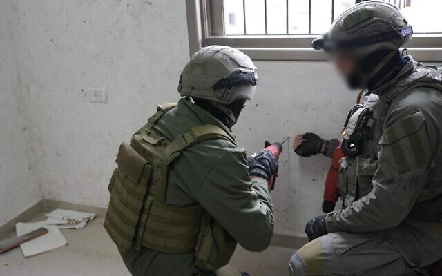 Police officers operate to seal the home of a Palestinian terrorist in East Jerusalen's Shuafat, February 18, 2024. (Israel Police) Police officers operate to seal the home of a Palestinian terrorist in East Jerusalen's Shuafat, February 18, 2024. (Israel Police)