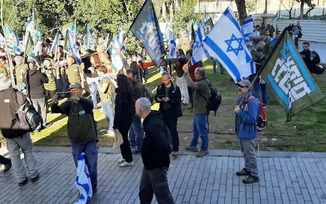 Protesters with Brothers in Arms gather outside the home of Housing Minister Yitzhak Goldknopf in Jerusalem on February 26, 2024. (Courtesy Adar Eyal/Brothers in Arms) Protesters with Brothers in Arms gather outside the home of Housing Minister Yitzhak Goldknopf in Jerusalem on February 26, 2024. (Courtesy Adar Eyal/Brothers in Arms)