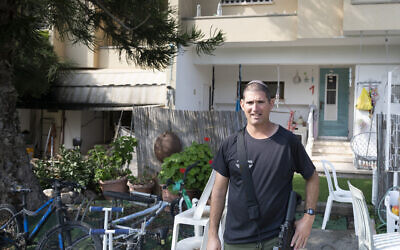 Adiel Ginzberg walks from his home in Kibbutz Sa'ad to carry out guard duties on February 6, 2024. (Canaan Lidor/Times of Israel)