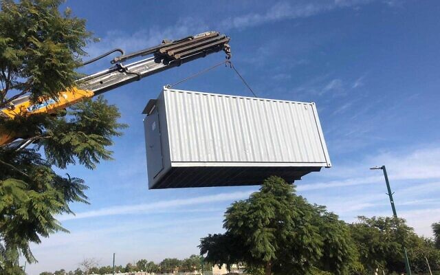 A crane places an equipment container for a civil defense team at a community in the Gaza periphery, February 4, 2024 (Defense Ministry)