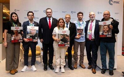Foreign Minister Israel Katz (3rd L) with relatives of hostages held in Gaza and other officials at the Munich Security Conference, Germany, February 16, 2024 (Boaz Arad)
