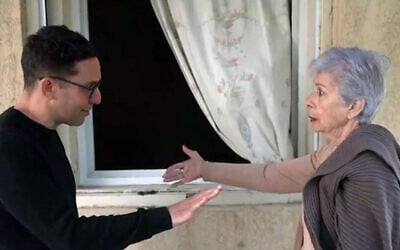 Jaqueline Glicksman (R), 81, recounts jumping out of her safe room's window to escape Hamas terrorists on October 7, on her first visit to her ruined home since the attacks, in a report aired February 1, 2024 (Channel 12 screenshot; used in accordance with Clause 27a of the Copyright Law)