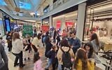 Israeli families enjoy a music headphone party at the TLV fashion mall in Tel Aviv during municipal election day on February 27, 2024. (Courtesy)