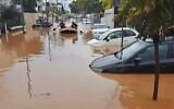 People row in an inflatable dinghy through flooded streets in central Israel, February 17, 2024 (Video screenshot; used in accordance with Clause 27a of the Copyright Law)