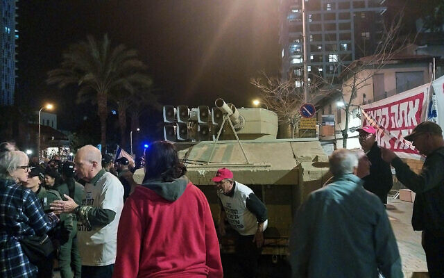 Veterans of the 1973 Yom Kippur War arrive at the anti-government protests in Tel Aviv with a life-size fake tank, October 16, 2024. (Iddo Schejter/Times of Israel)