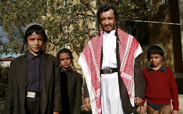 File: Yemeni Jewish Rabbi Yahia Yussef Mussa (C), sporting a chequered Keffiya, poses for a picture with unidentified young relatives outside his apartment in the Yemeni capital Sanaa on January 18, 2010. (Ahmad Gharabli / AFP)