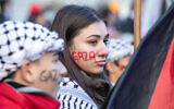 Illustrative: Demonstrators in support of Palestinians wear 'Gaza' painted on their faces during a rally to call for a ceasefire in the Israel-Hamas war, at Dorchester Square in Montreal, Quebec, Canada, on November 18, 2023. (Alexis Aubin/AFP)