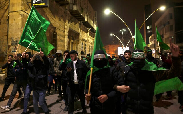 Illustrative: Hamas supporters in the West Bank city of Hebron demonstrate on January 2, 2024, against an Israeli strike in Lebanon that killed the terror group's deputy leader. (Hazem Bader/AFP)